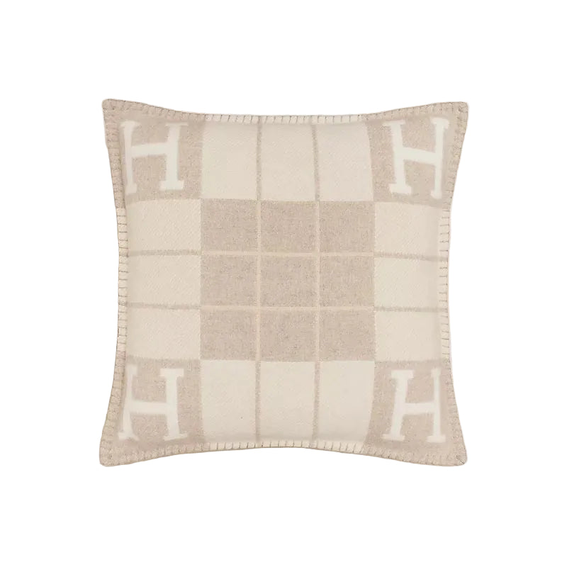 Checkered pillow with 'H' pattern on a light background