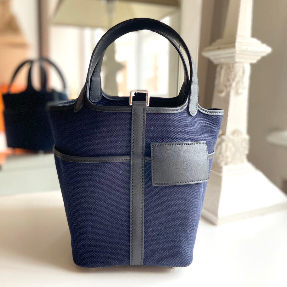 Hermès Picotin 18 Cargo in Bleu Marine Toile Goeland canvas with Black Swift leather trim, styled front view