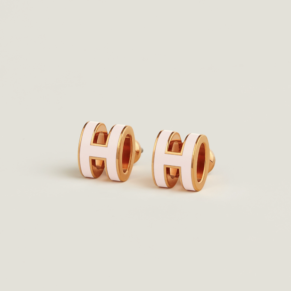 A pair of rose gold-plated lacquered metal earrings with a geometric pattern.
