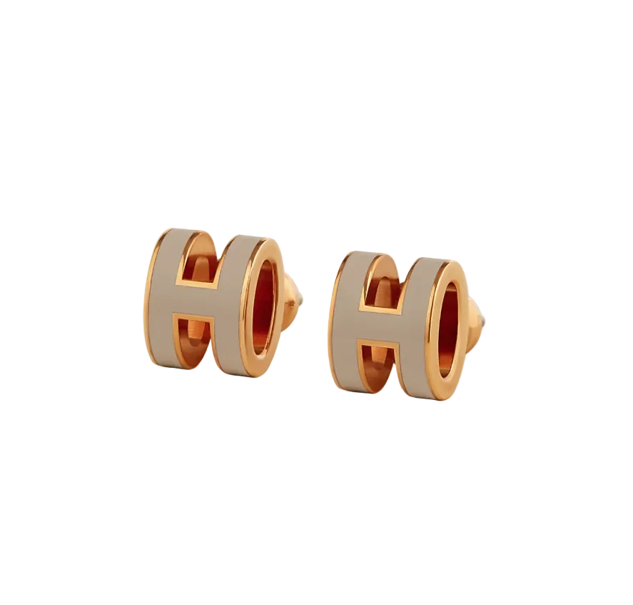 A pair of rose gold-plated Hermes Mini Pop H earrings with a marron glacé metallic finish.