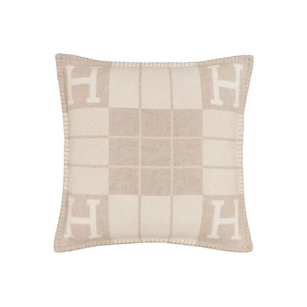 Checkered pillow with 'H' pattern on a light background