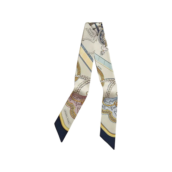 Decorative scarf with intricate patterns on a light beige background