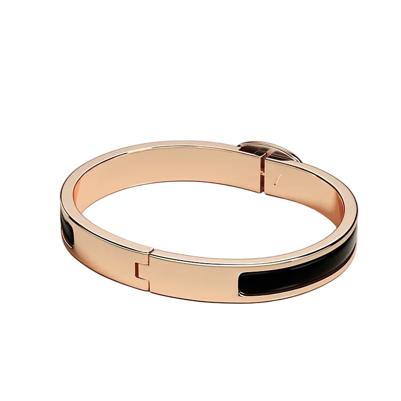 Rose gold bracelet with black interior on a light gray background